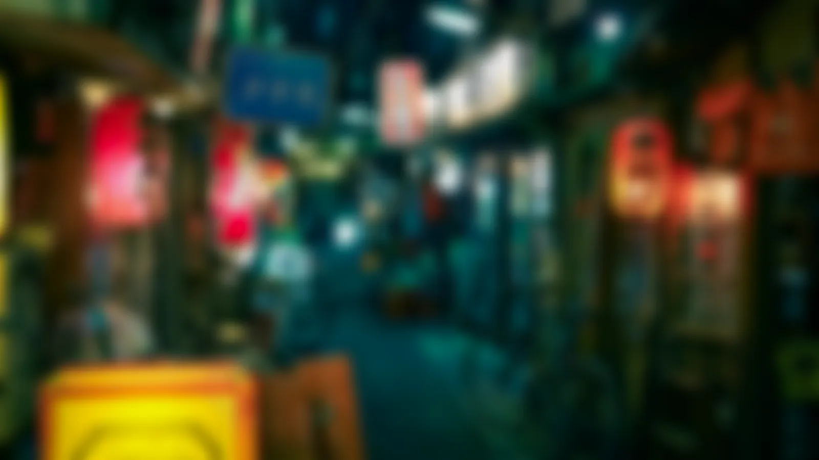 A night-time alley of small bars lined with paper lanterns (real photo, blurred)