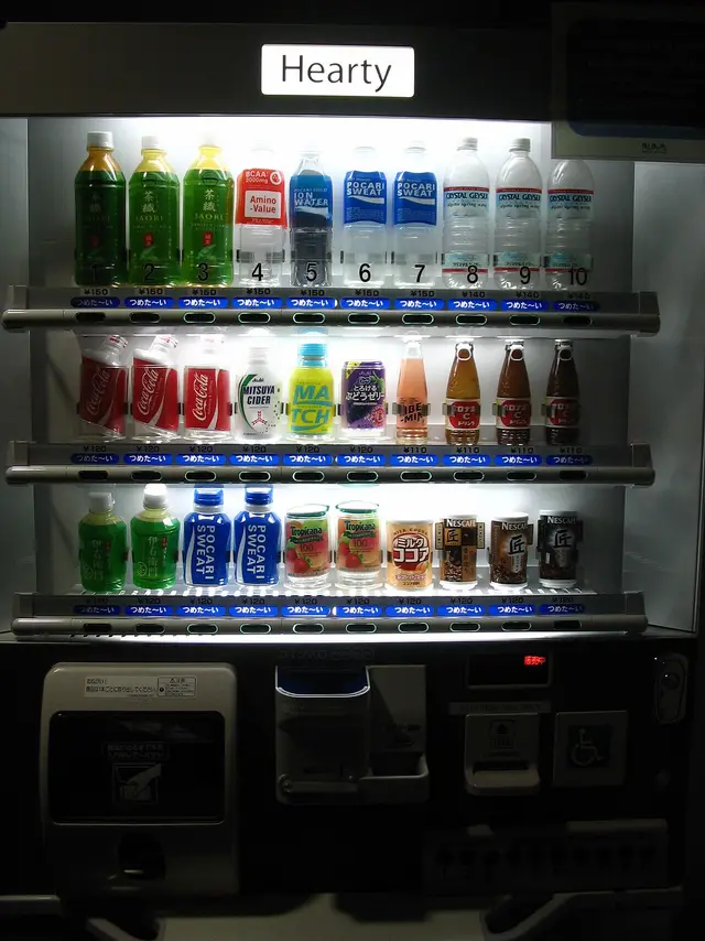 A Japanese drink vending machine stocked with cold bottled drinks